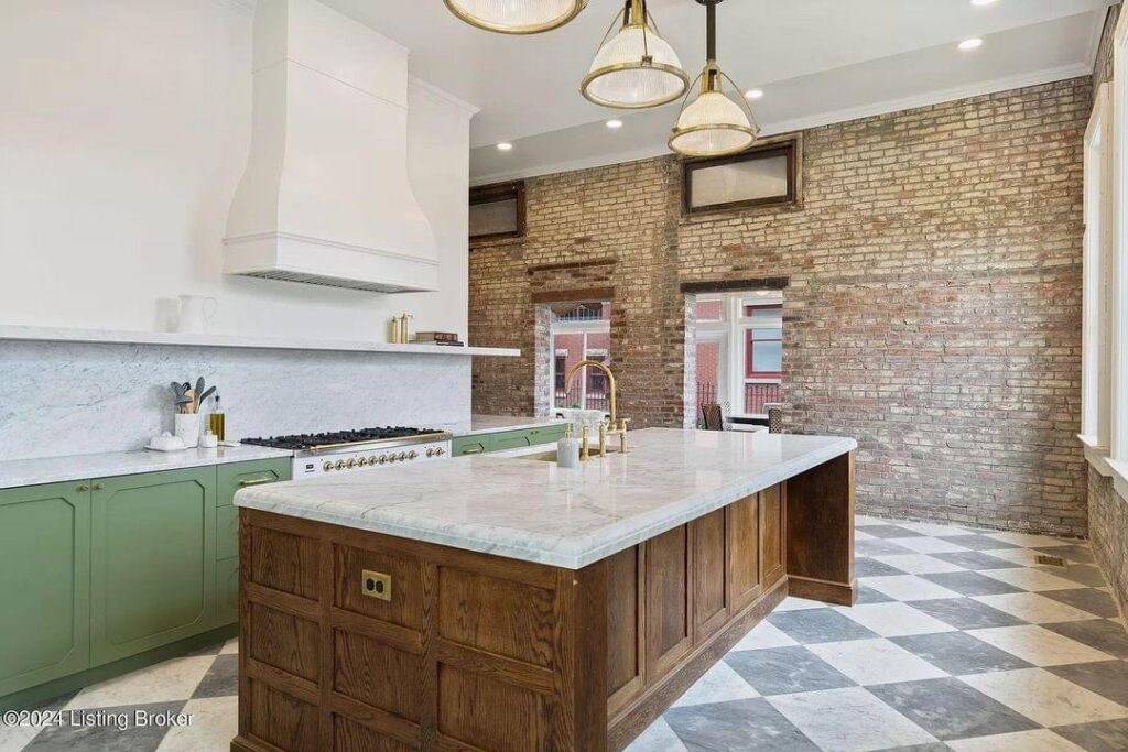 light bright rooms, sage green kitchen cabinets with checkerboard tile floors and wood with white marble center island and white and gold stove