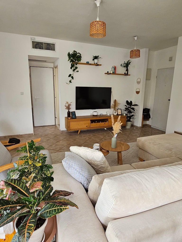 light bright rooms, tel aviv apartment with beige furniture and green houseplants and lots of natural light