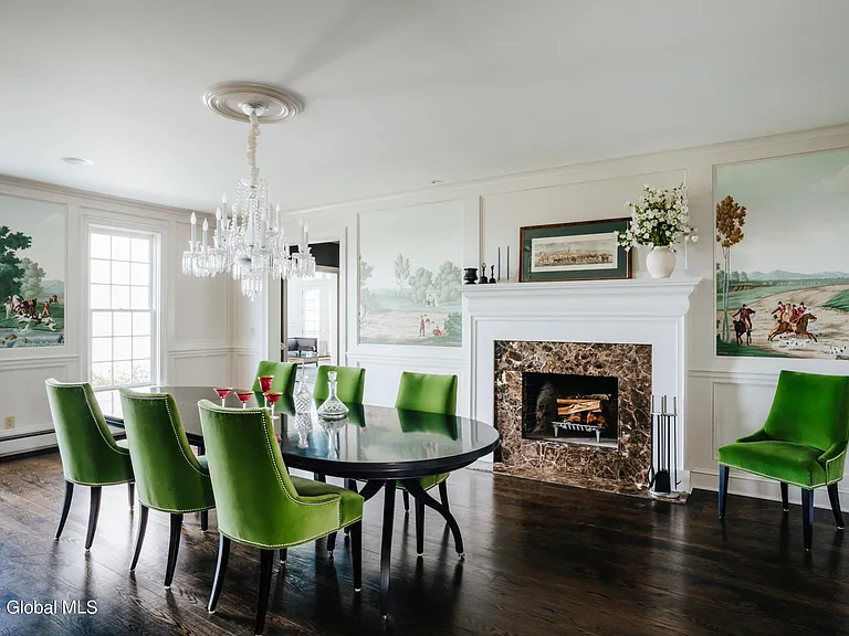 Valatie NY Equestrian Estate, modern industrial dining room with black dining room table and green velvet chairs with large chandelier