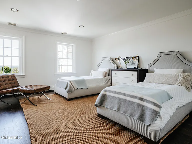 Valatie NY Equestrian Estate, miminalist modern bedroom with high ceilings and two queen beds