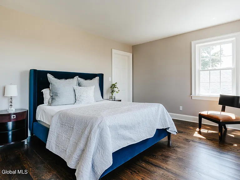 Valatie NY Equestrian Estate, miminalist modern bedroom with high ceilings and two queen beds