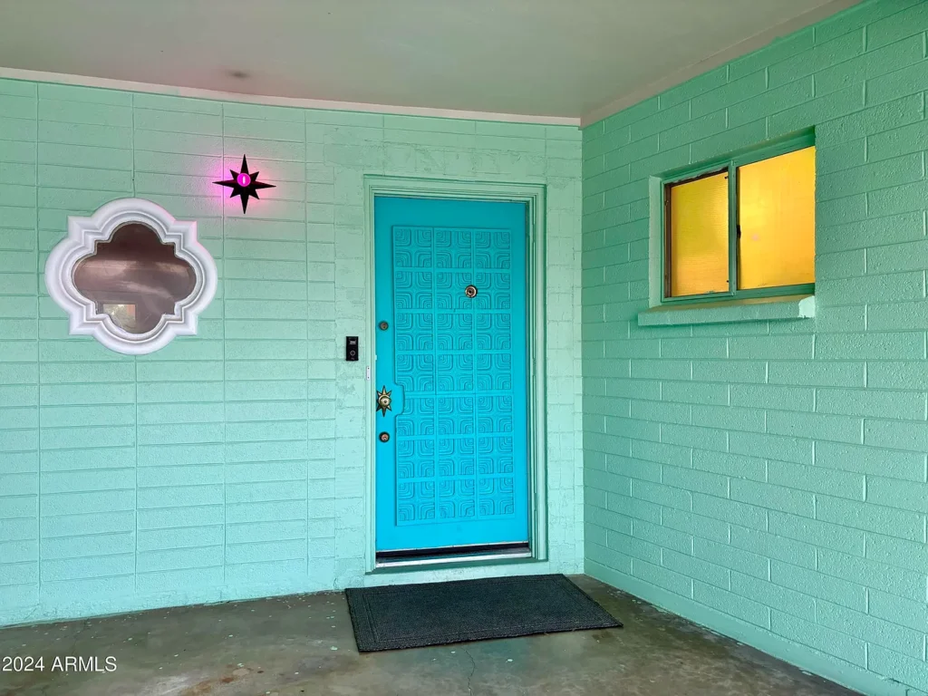 1950s suburban family life home, phoenix arizona 1957 ranch style home with original pink and teal decor and blue front door