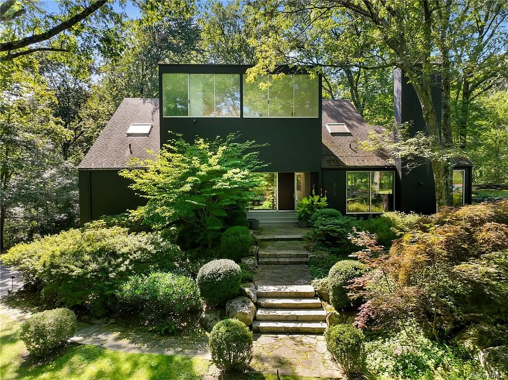 modern chappaqua, ny house, modern black exterior paint with large windows and dark decking