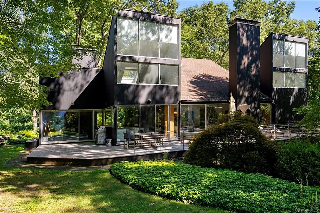 modern chappaqua, ny house, modern black exterior paint with large windows and dark decking