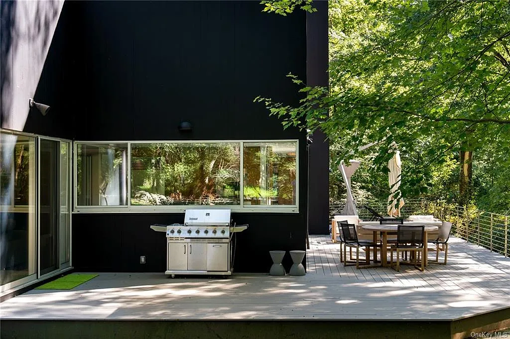 modern chappaqua, ny house, modern black exterior paint with large windows and dark decking