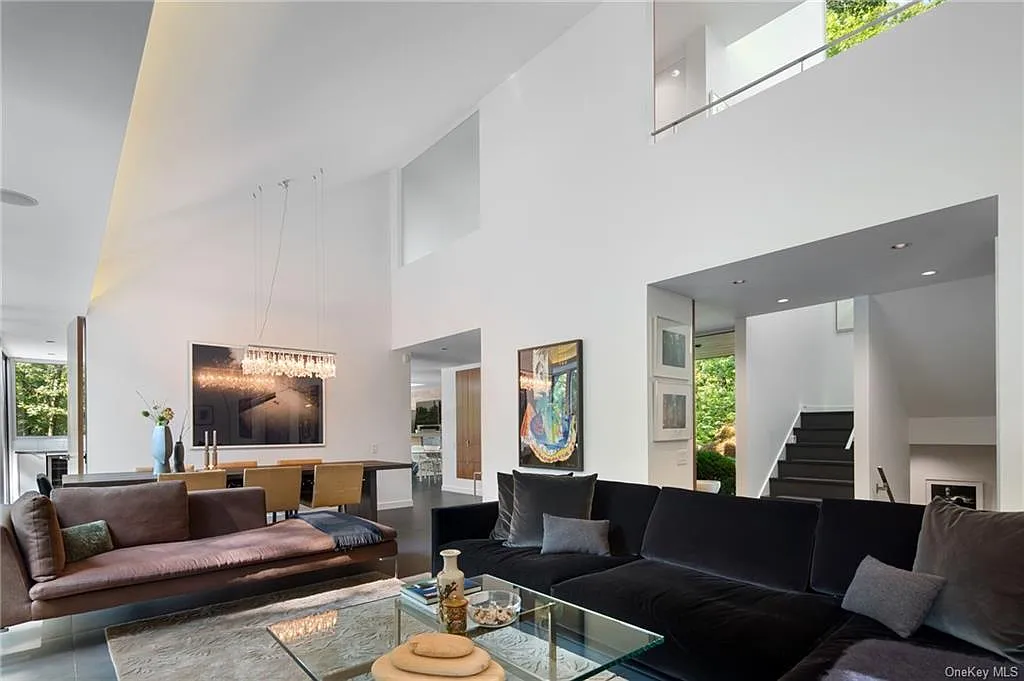 modern chappaqua, ny house, modern interior design with black sofa and vaulted ceilings