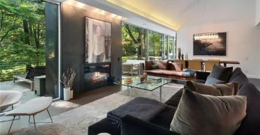 modern chappaqua, ny house, modern interior design with black sofa and vaulted ceilings