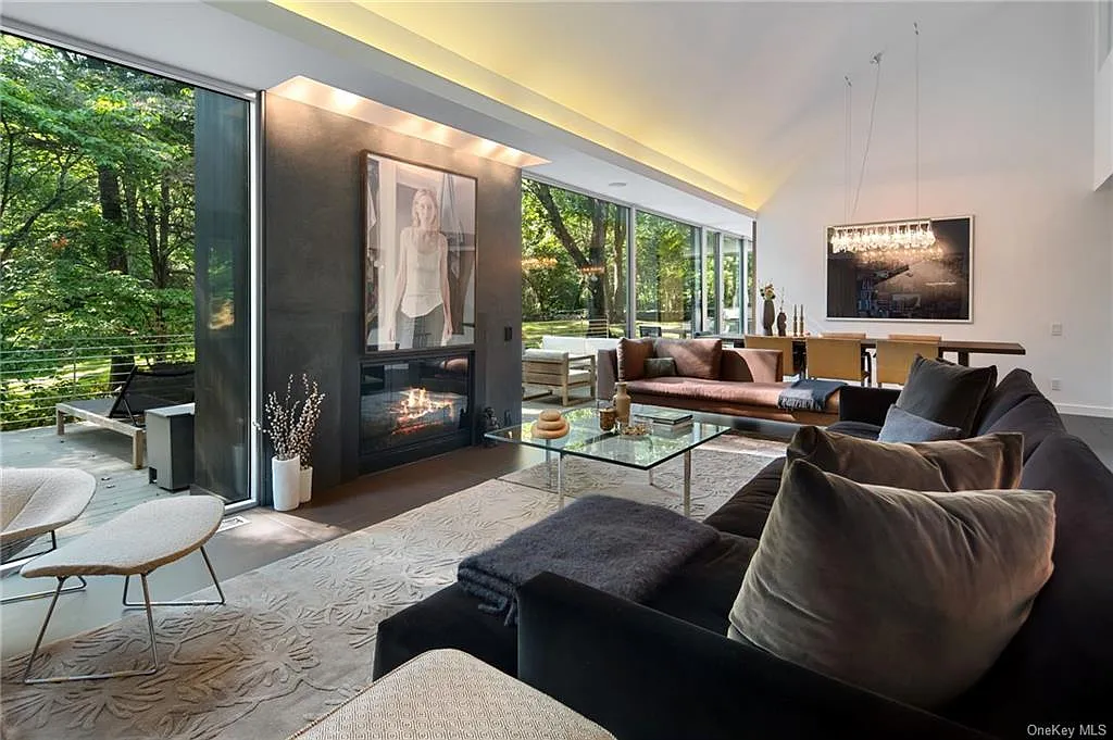 modern chappaqua, ny house, modern interior design with black sofa and vaulted ceilings