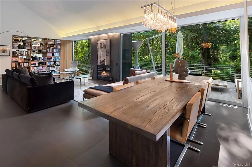 modern chappaqua, ny house, modern interior design with black sofa and vaulted ceilings and large dining space