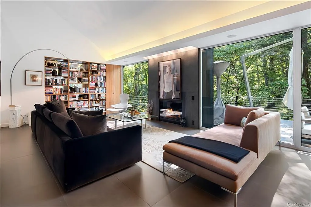 modern chappaqua, ny house, modern interior design with black sofa and vaulted ceilings