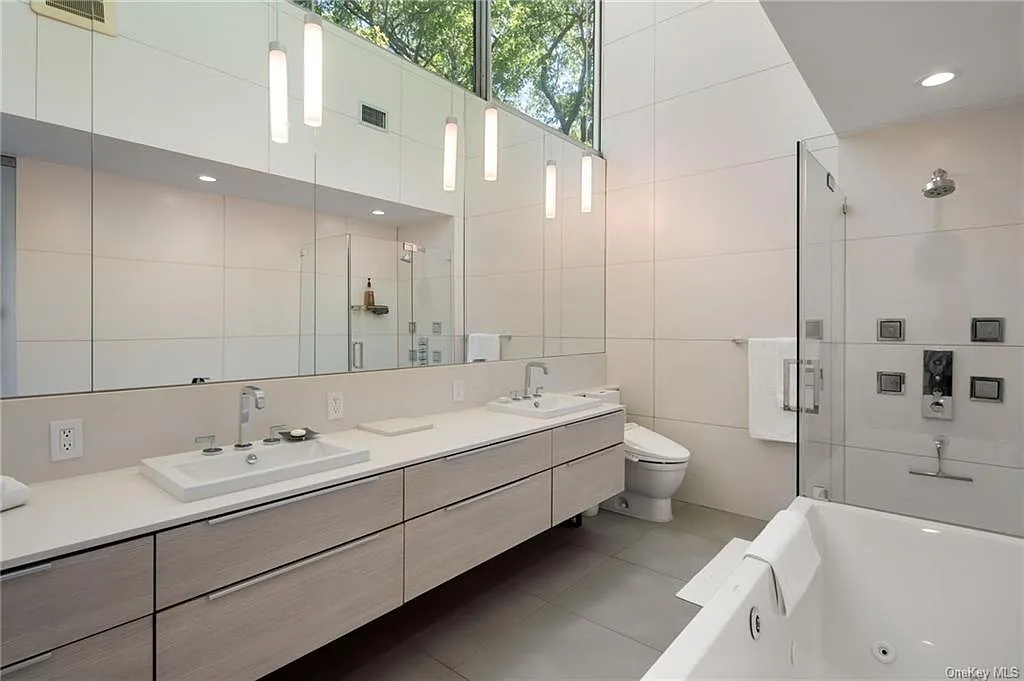 modern chappaqua, ny house, modern interior design bathroom with soft gray tile and a double vanity