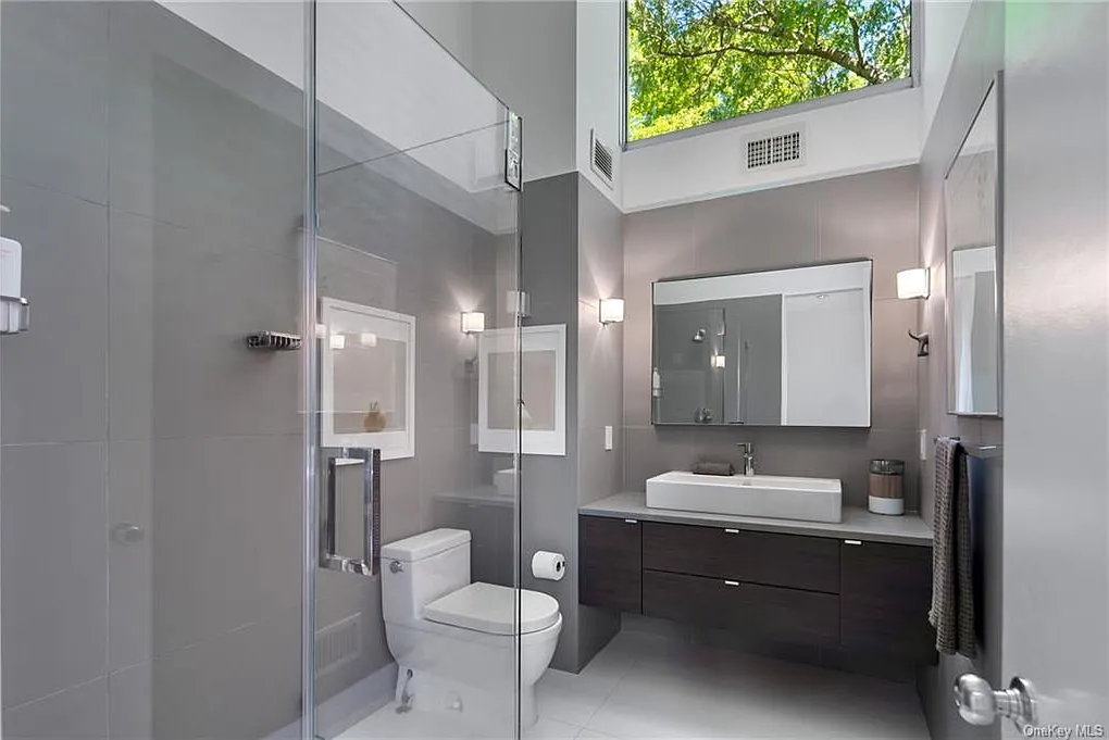 modern chappaqua, ny house, modern interior design bathroom with soft gray tile and a double vanity