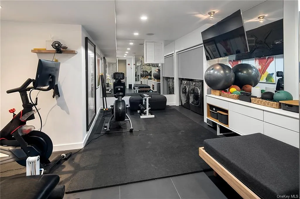 modern chappaqua, ny house, modern interior design home gym with vaulted ceilings and skylights