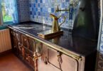 claude monet's kitchen in giverny france, with rich metal and blue tile finishes