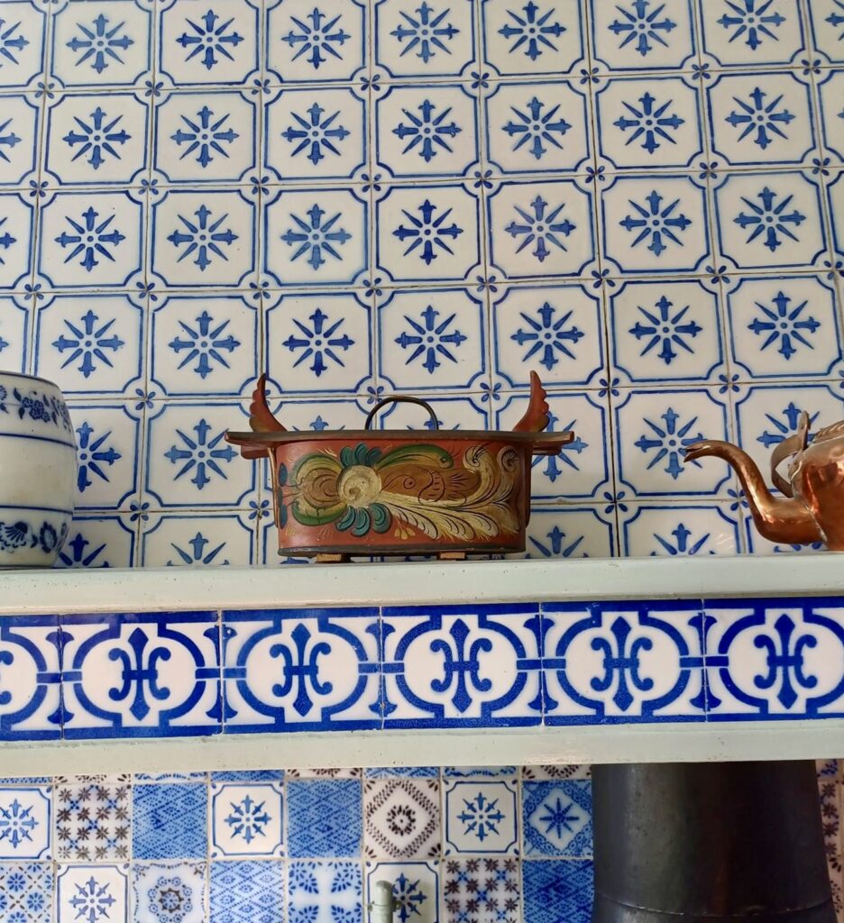 claude monet's kitchen in giverny france, with rich metal and blue tile finishes