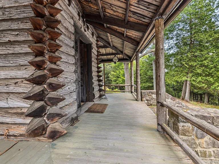 Keene Valley NY house with wood walls and ceilings and log cabin exterior and wrap around log porch