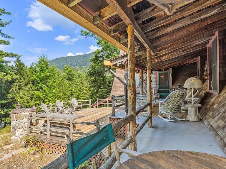 Keene Valley NY house with wood walls and ceilings and log cabin exterior and wrap around log porch