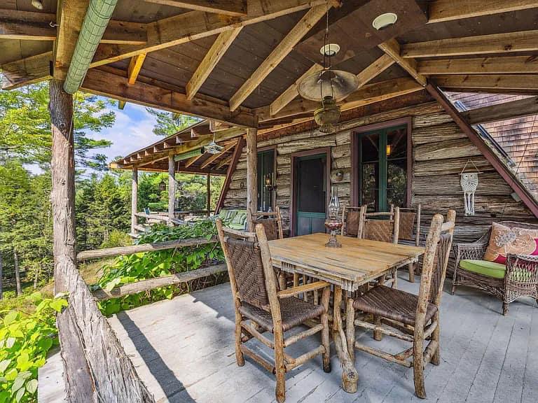 Keene Valley NY house with wood walls and ceilings and log cabin exterior and wrap around log porch