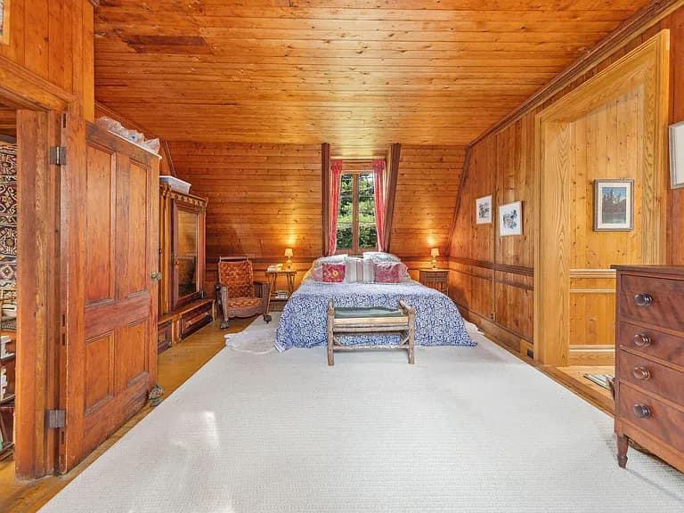 Keene Valley NY house with wood walls and ceilings and log cabin master bedroom