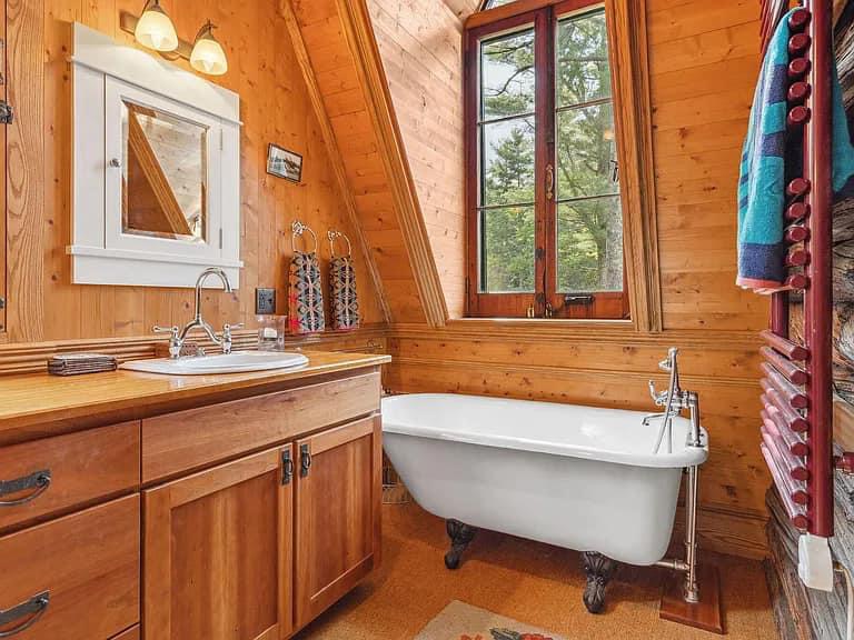 Keene Valley NY house with wood walls and ceilings and clawfoot antique white tub