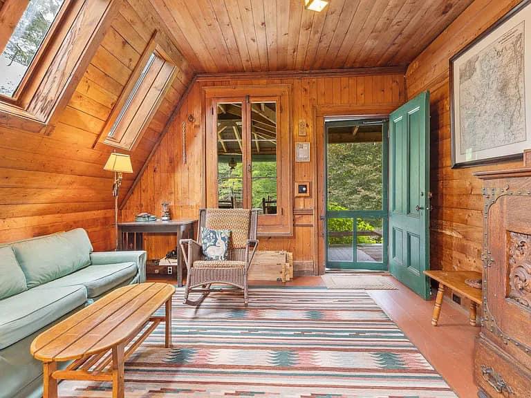 Keene Valley NY house with wood walls and ceilings and log cabin exterior with bright den