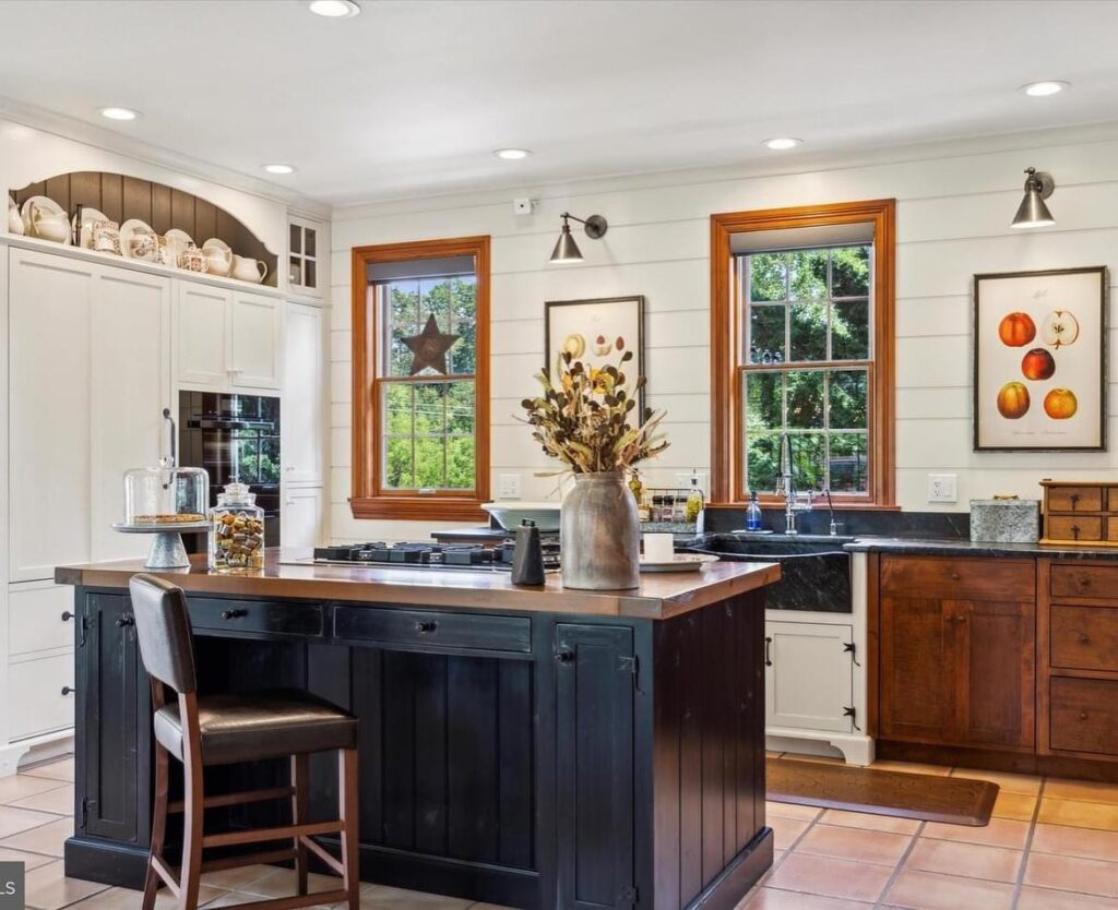 light bright rooms, black and white modern neutral kitchen with classic natural wood trim and an oversized black farmhouse kitchen sink