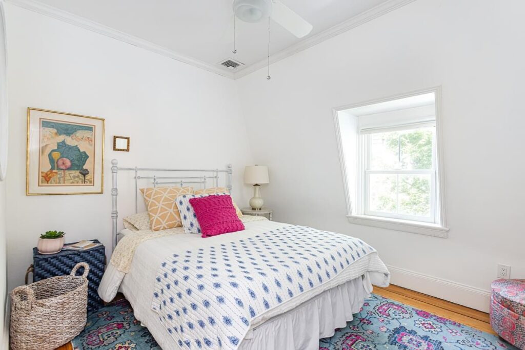 light bright rooms, modern neutral master bedroom with blue persian area rug and textured bedspread