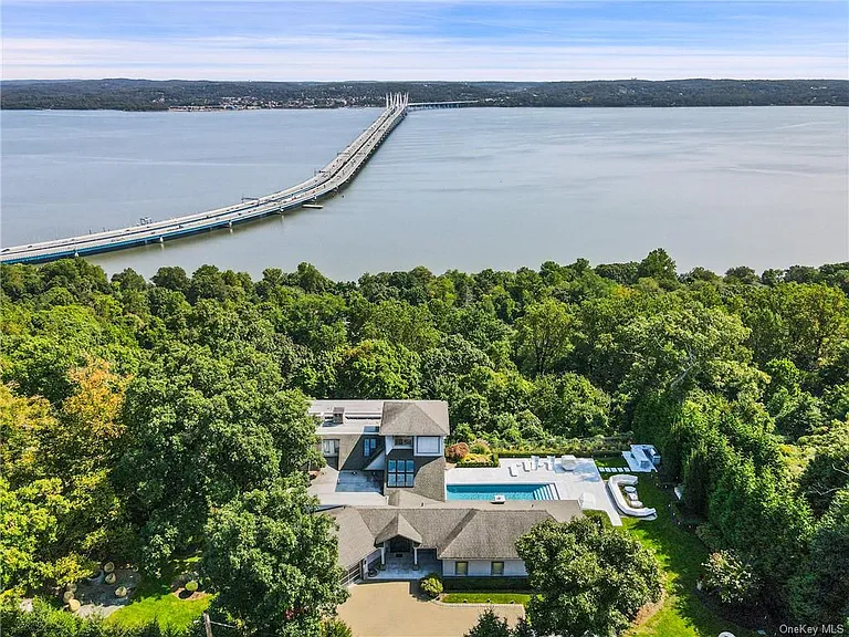 Modern Nyack, NY Palace with windows overlooking the hudson river with an in-ground pool