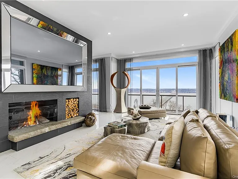 Modern Nyack, NY Palace with windows overlooking the hudson river, sleek modern den and living room with river views