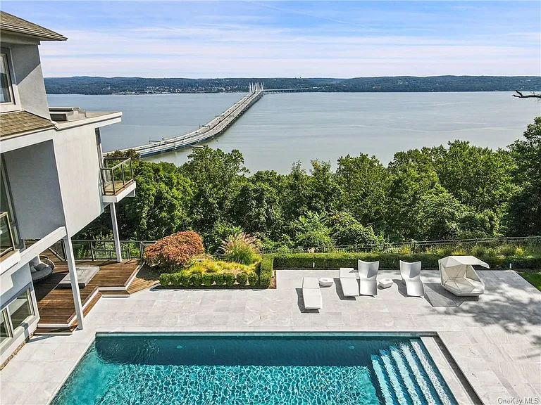 Modern Nyack, NY Palace with windows overlooking the hudson river with an in-ground pool