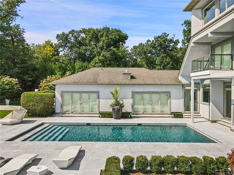 Modern Nyack, NY Palace with windows overlooking the hudson river with an in-ground pool