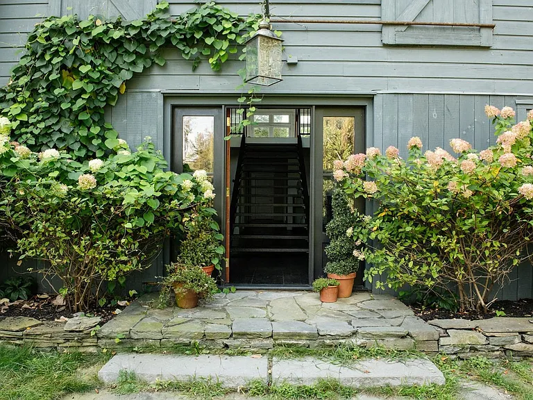 converted dairy barn in accord ny with english countryside design and green ivy