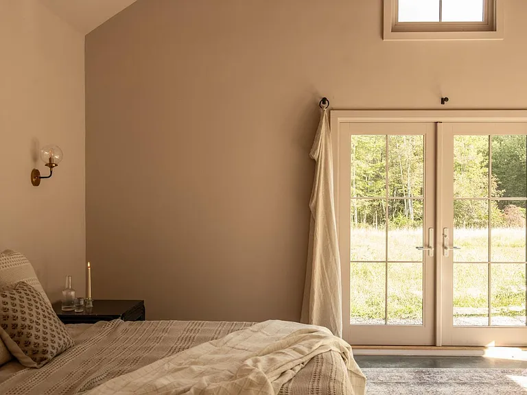 converted dairy barn in accord ny, modern country bedroom with vaulted ceilings and french doors