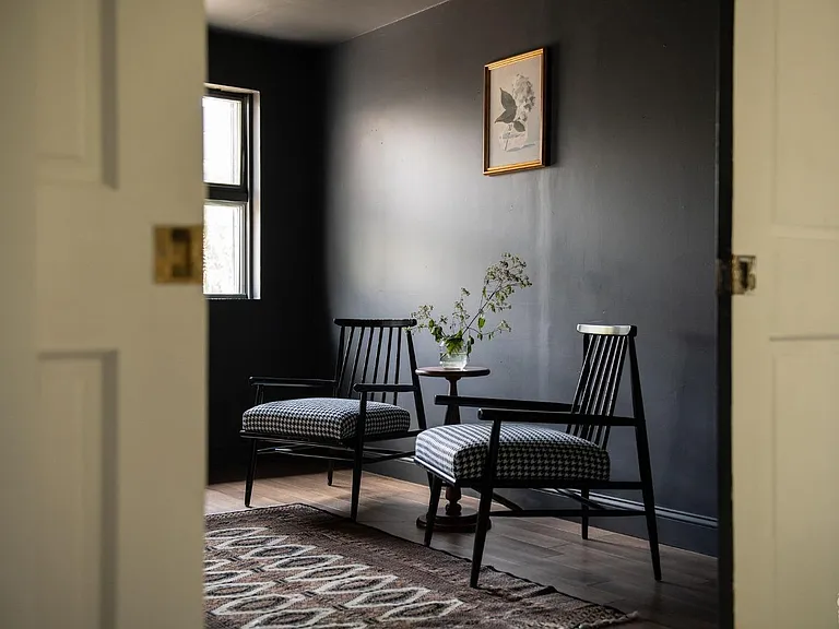 converted dairy barn in accord ny, modern country sitting room with black walls and natural light