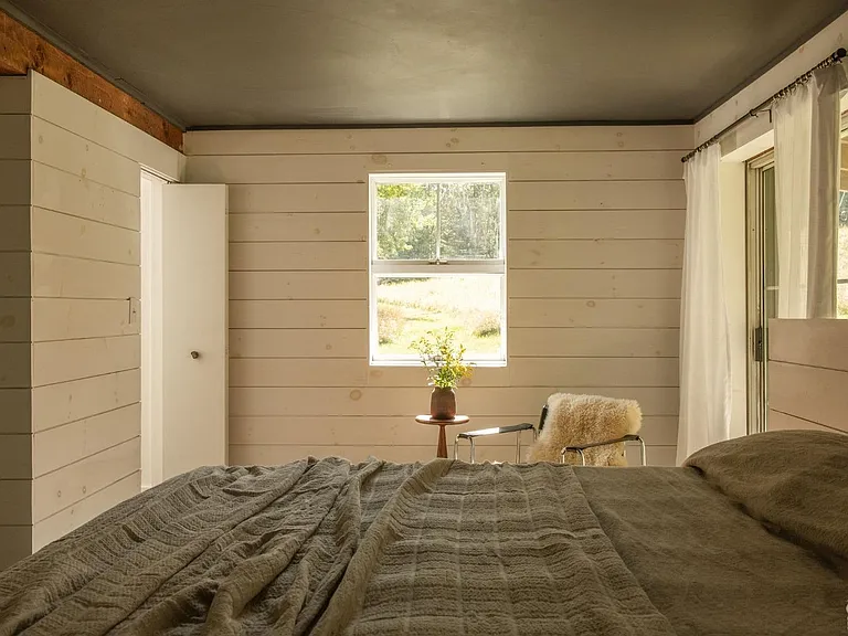 converted dairy barn in accord ny, modern country bedroom with textured walls and natural light