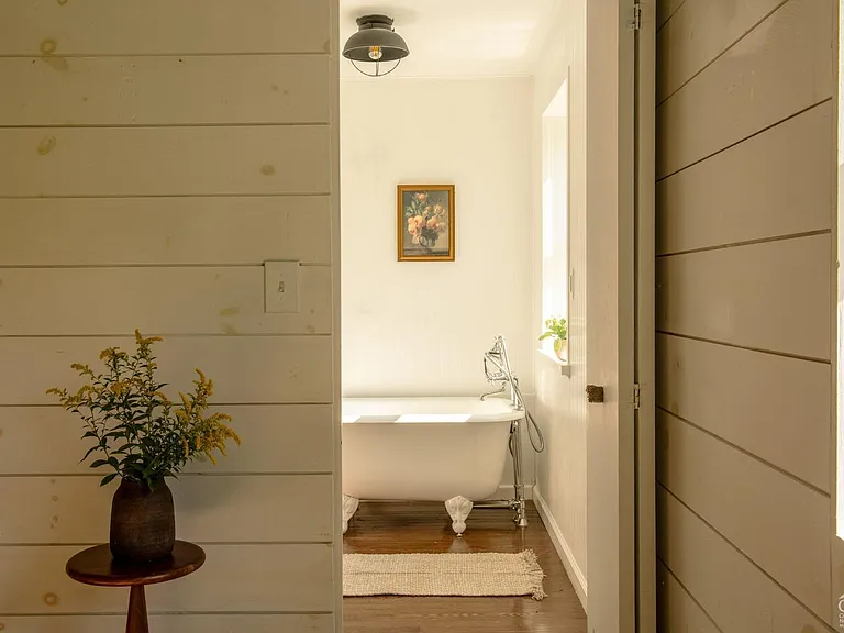 converted dairy barn in accord ny, modern country master bedroom with footed tub in master bedroom