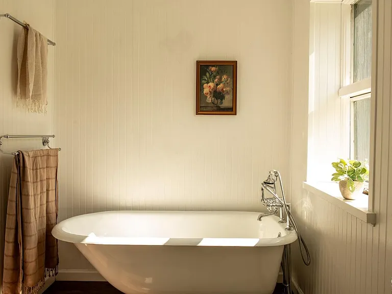 converted dairy barn in accord ny, modern country master bedroom with footed vintage tub in master bedroom