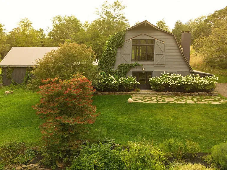 converted dairy barn in accord ny, modern country home exterior with lush greenery