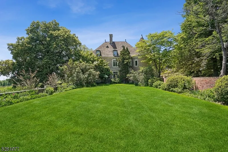 massive NJ castle in chester township listed for $4 million, exterior with lush green forests