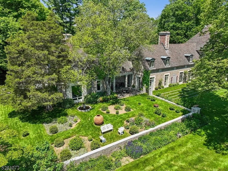 massive NJ castle in chester township listed for $4 million, exterior with lush green forests and perfect landscaping