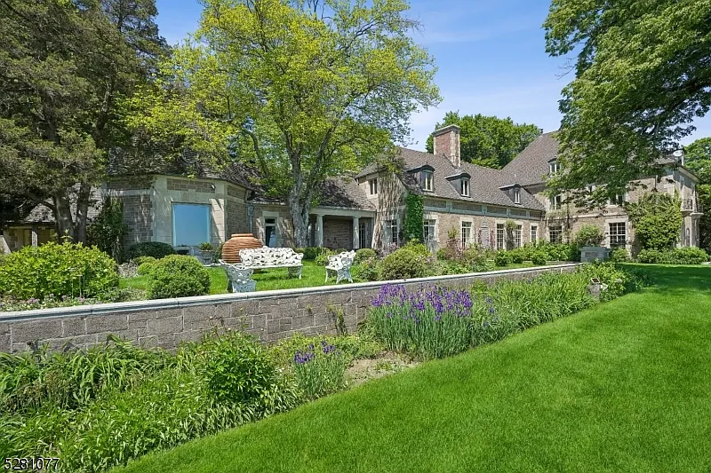 massive NJ castle in chester township listed for $4 million, exterior with lush green forests and perfect landscaping