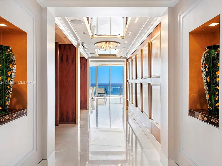 Fort Lauderdale Beach Penthouse, floor to ceiling windows overlooking the atlantic ocean from a stately marble entrance and hallway