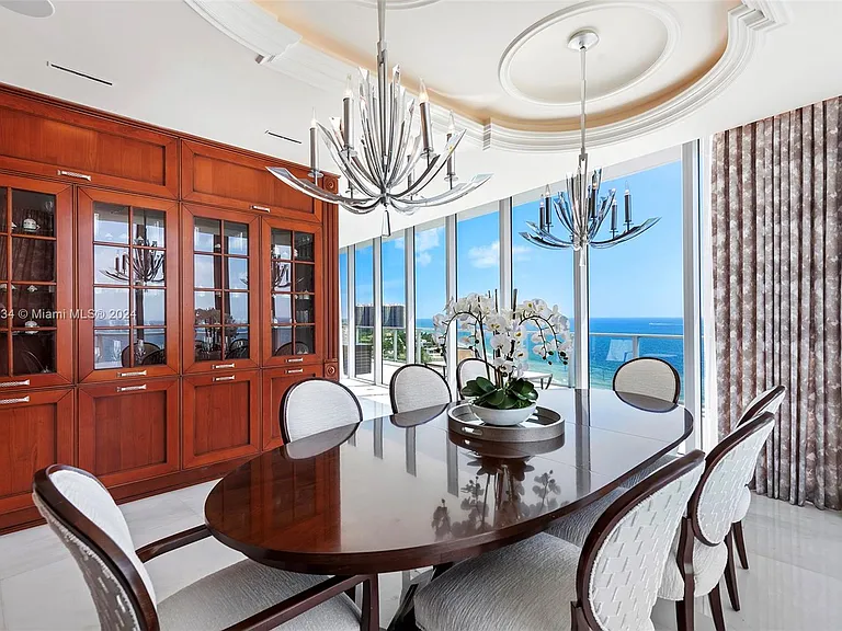 Fort Lauderdale Beach Penthouse, large modern dining room with chandelier overlooking the atlantic ocean