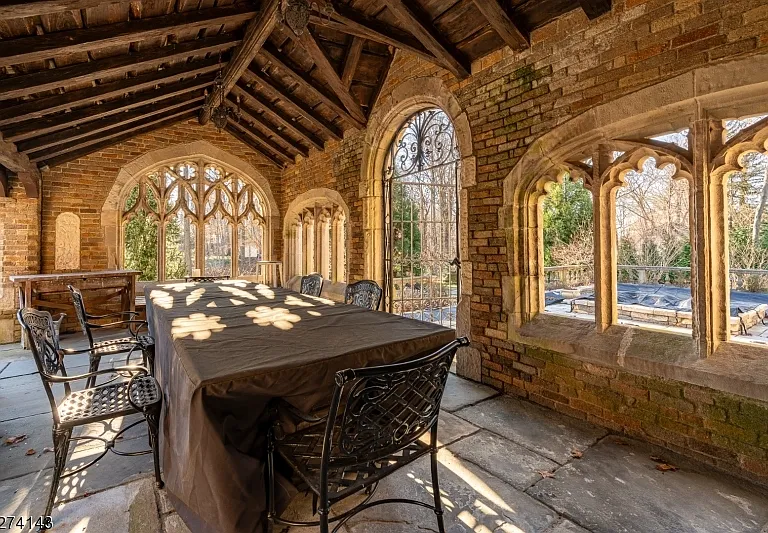 tudor style castle in NJ, large stone dining room with vaulted ceilings and a massive table