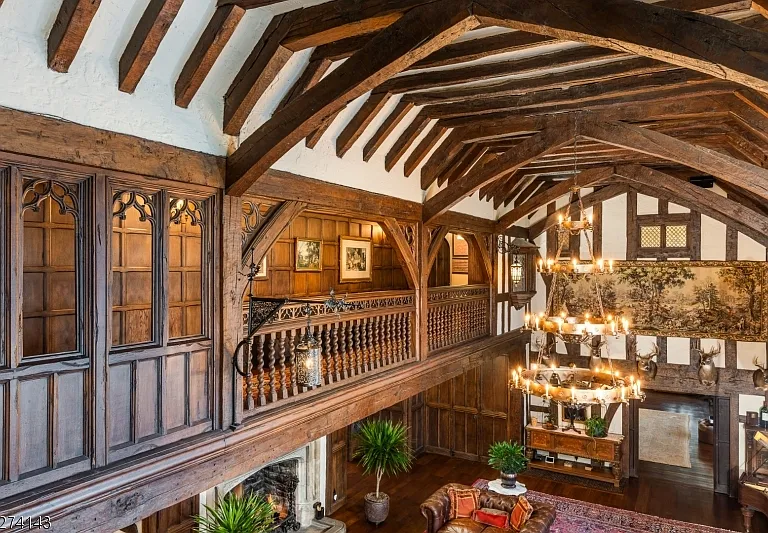 tudor style castle in NJ, large foyer with dark wood vaulted ceiling detailing and stairs