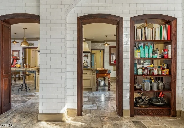 tudor style castle in NJ, large foyer with dark wood vaulted round doorways 