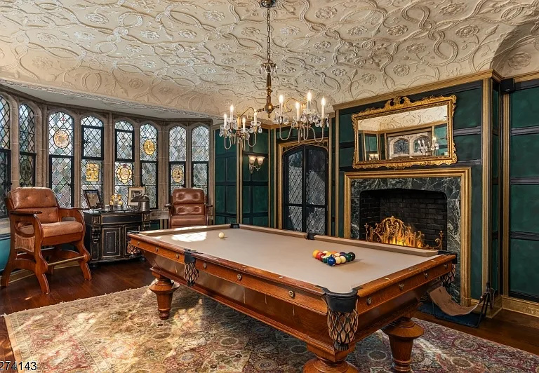 tudor style castle in NJ, antique billiards room with wood detailing and chandelier