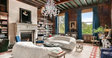 fifth ave nyc mansion listed for $58 million, interior of 973 fifth avenue with 16 foot ceilings and wood beams