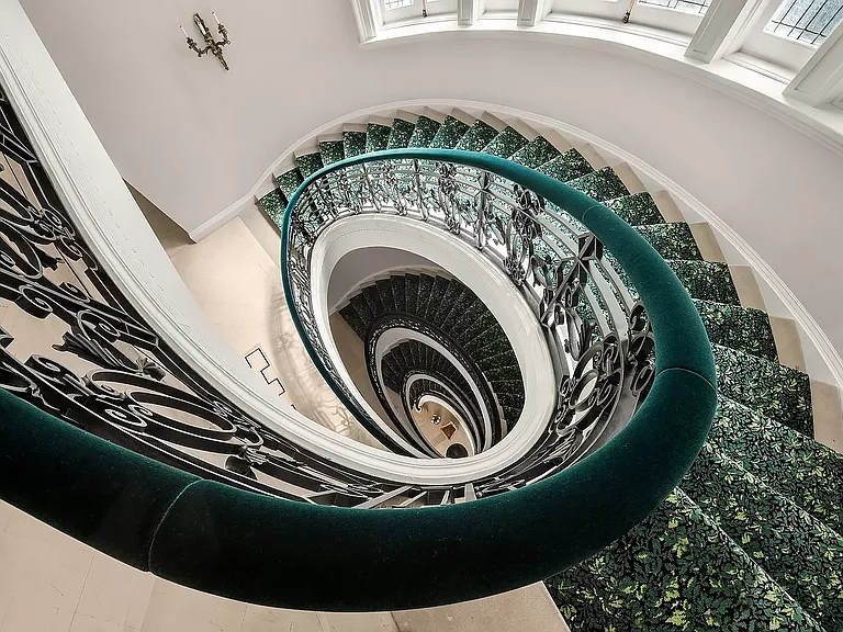 fifth ave nyc mansion listed for $58 million, interior of 973 fifth avenue with massive spiral staircase