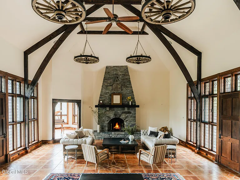 massive catskills ny castle for sale in sullivan county, arched tudor style living room with vaulted ceilings